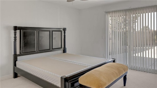 bedroom featuring baseboards and light colored carpet