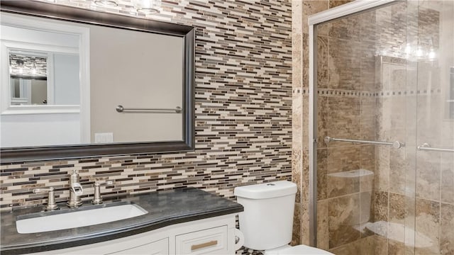 full bathroom with tasteful backsplash, tile walls, toilet, a stall shower, and vanity