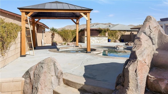 view of patio featuring a gazebo, a fenced backyard, and a fenced in pool