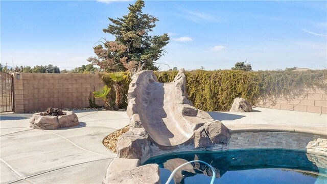 view of pool featuring fence