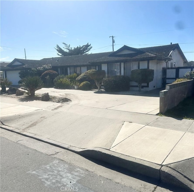 single story home with concrete driveway