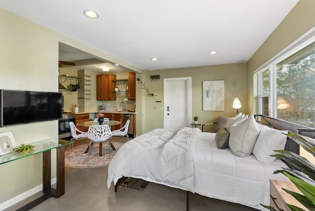 bedroom with recessed lighting, a sink, baseboards, and concrete floors