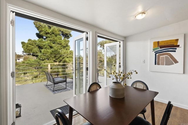 dining space featuring baseboards and wood finished floors