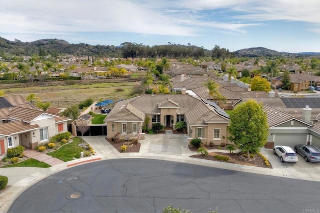 drone / aerial view featuring a residential view and a mountain view