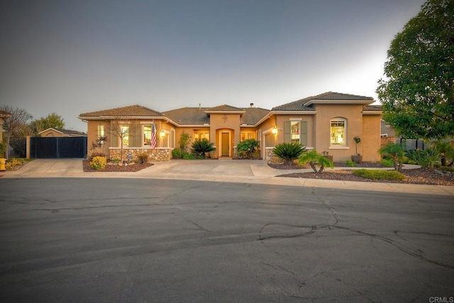 2682 Dundee Gln, Escondido, CA 92026 - mediterranean / spanish house featuring concrete driveway, stucco siding, a garage, and a tiled roof