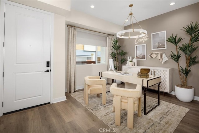 dining area featuring a chandelier, recessed lighting, wood finished floors, and baseboards