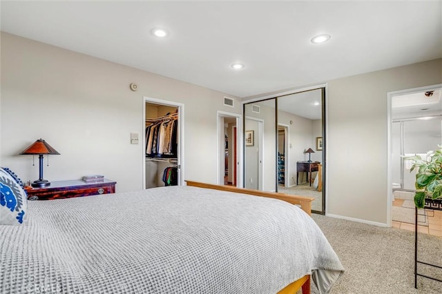 carpeted bedroom with ensuite bathroom, recessed lighting, visible vents, baseboards, and a closet