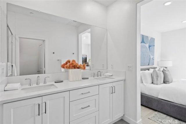 full bathroom featuring ensuite bathroom, double vanity, and a sink