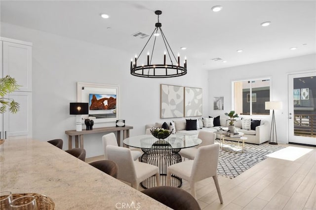 dining area featuring an inviting chandelier, light wood-style flooring, visible vents, and recessed lighting