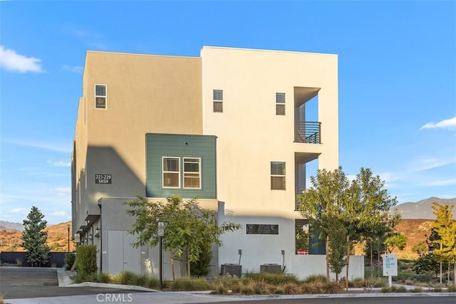 exterior space with central AC unit and a mountain view