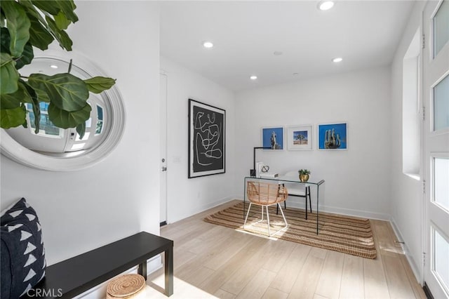 office space featuring baseboards, wood finished floors, and recessed lighting