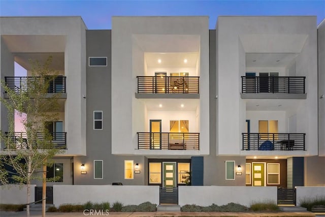 back of property featuring visible vents and stucco siding