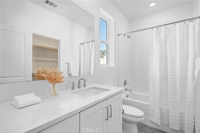 bathroom featuring toilet, shower / bath combo with shower curtain, vanity, and visible vents