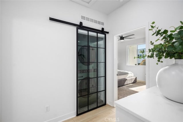 bathroom with ceiling fan, a sink, visible vents, and baseboards