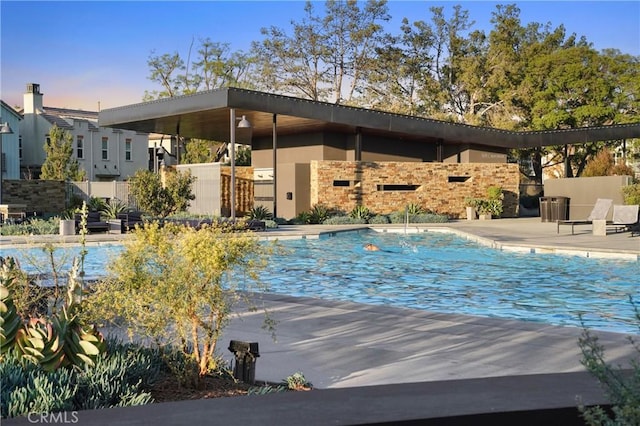 community pool featuring a patio area and fence