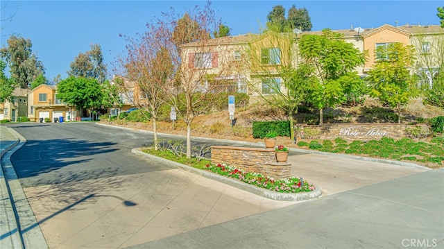 view of street with curbs and a residential view