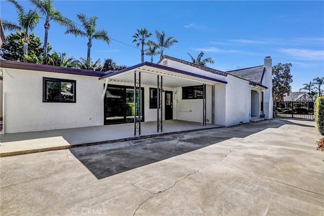 view of front facade featuring concrete driveway and stucco siding