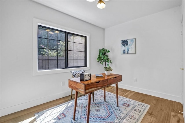 office with wood finished floors and baseboards