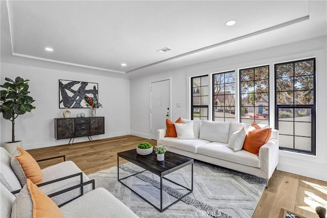 living room featuring baseboards, wood finished floors, visible vents, and recessed lighting