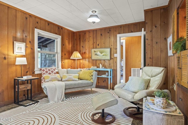 living room featuring visible vents and wooden walls