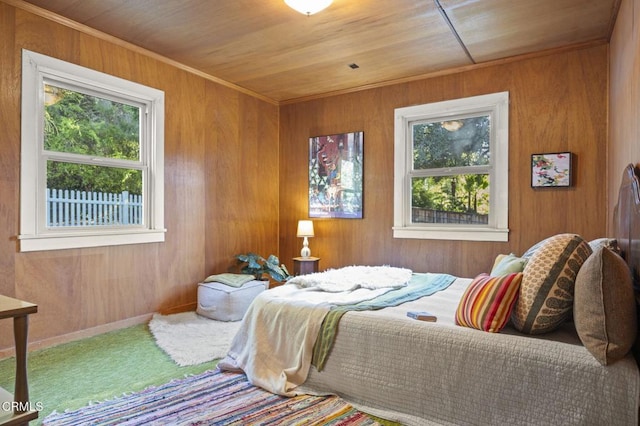 bedroom featuring wood walls, wood ceiling, and carpet flooring