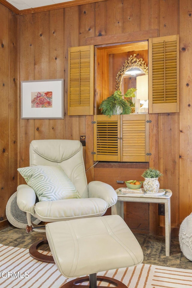 sitting room featuring wooden walls