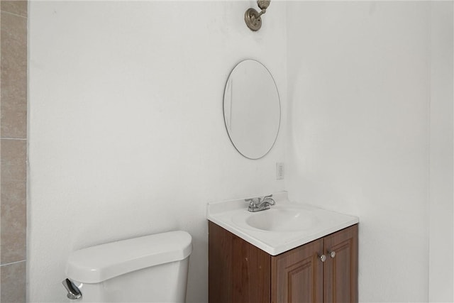 half bathroom with toilet and vanity