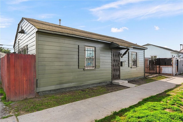 view of side of property featuring fence