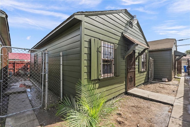 view of outdoor structure featuring a gate and fence