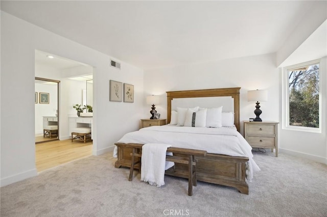 bedroom with carpet, visible vents, and baseboards