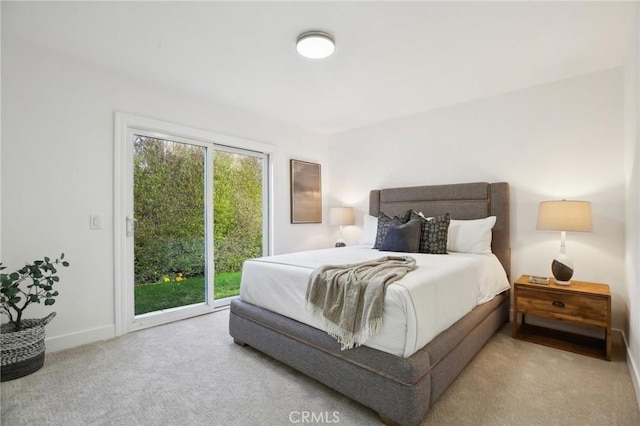 carpeted bedroom with access to exterior, multiple windows, and baseboards