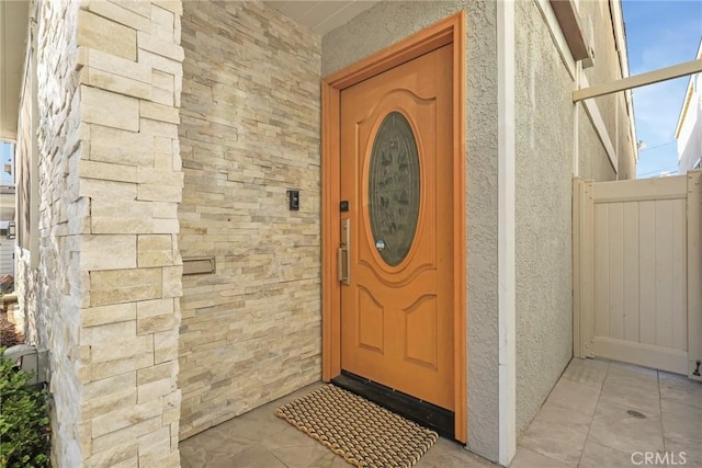 entrance to property featuring stucco siding