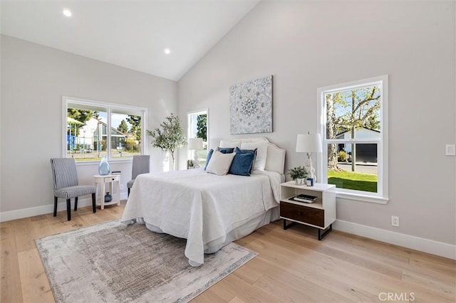 bedroom with high vaulted ceiling, recessed lighting, light wood-style flooring, and baseboards