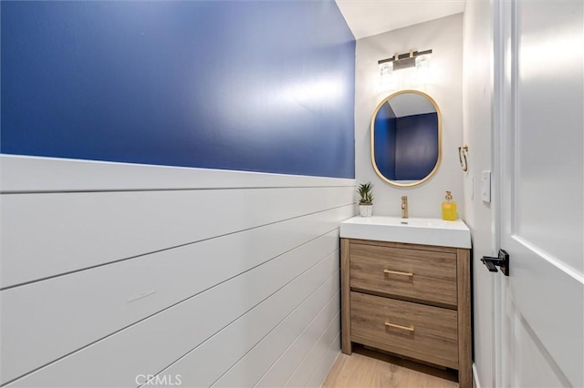 bathroom featuring wood finished floors and vanity