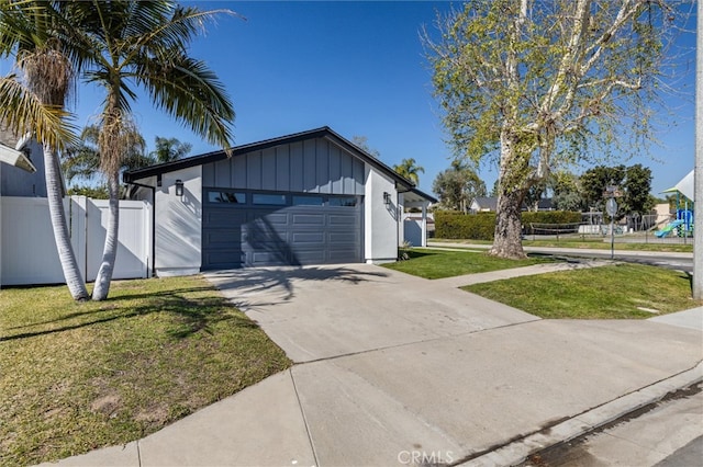 garage featuring driveway and fence