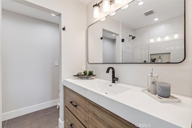 full bathroom featuring recessed lighting, vanity, visible vents, baseboards, and walk in shower