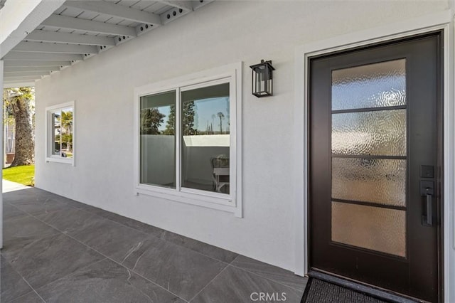 entrance to property with stucco siding