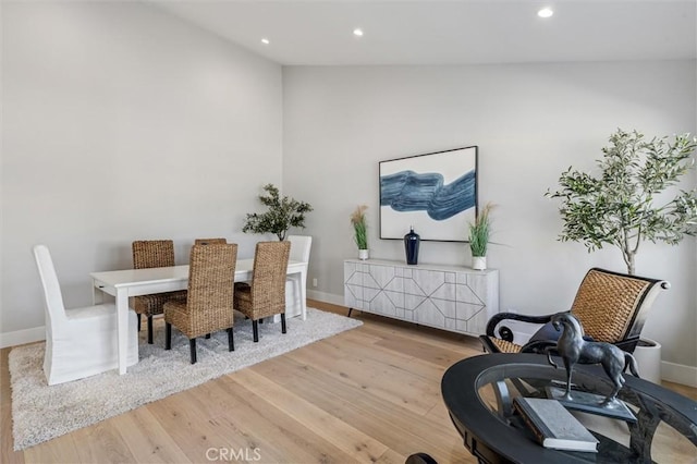 living area with lofted ceiling, baseboards, wood finished floors, and recessed lighting