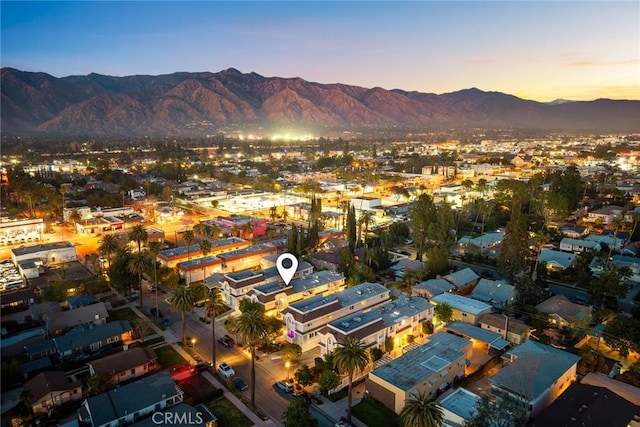 aerial view at dusk featuring a mountain view