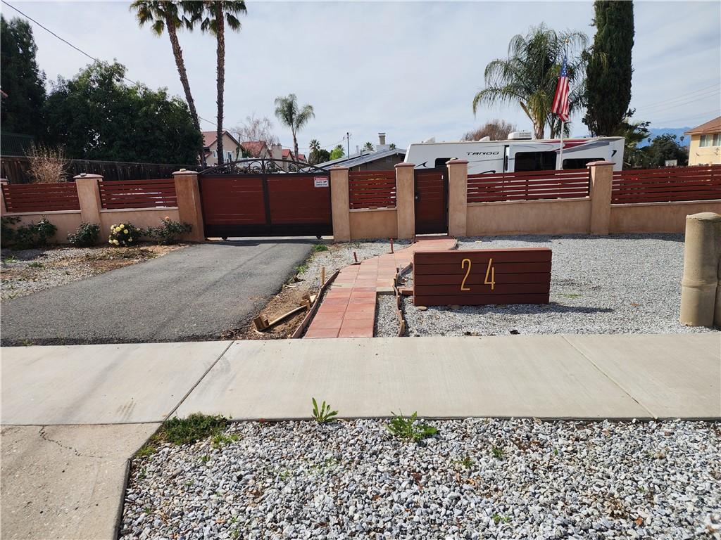 view of road featuring a gate and driveway