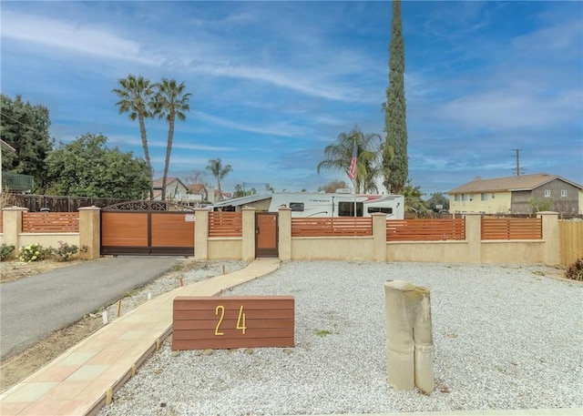 view of yard with a fenced front yard and a gate