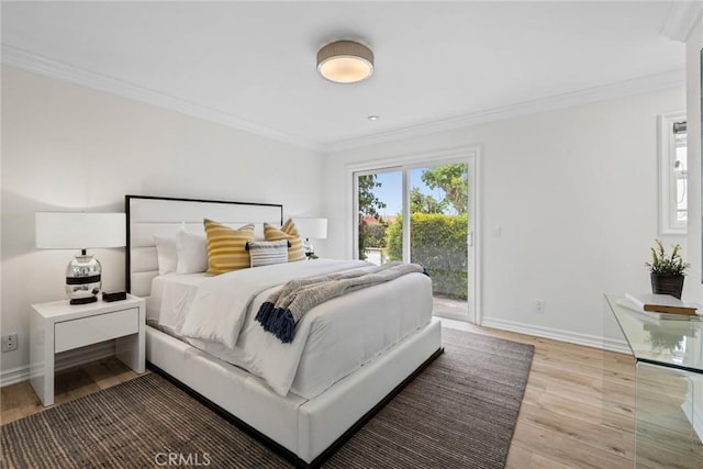 bedroom with access to exterior, baseboards, crown molding, and wood finished floors