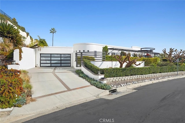 view of front of property with fence and concrete driveway