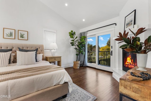 bedroom with recessed lighting, wood finished floors, baseboards, access to exterior, and a glass covered fireplace