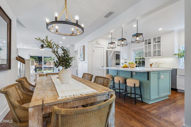 dining room featuring dark wood-style floors, a notable chandelier, visible vents, and recessed lighting