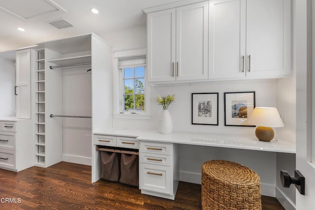 office space with visible vents, dark wood-style flooring, built in desk, and recessed lighting