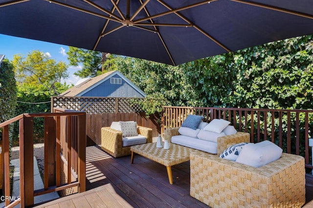 wooden deck with an outdoor hangout area and an outdoor structure