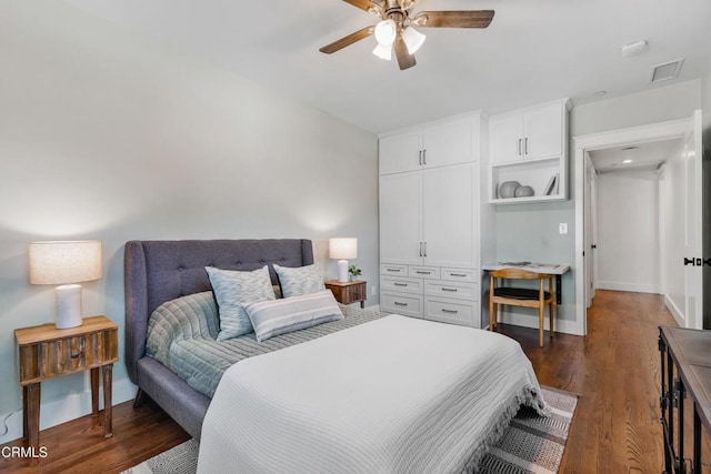 bedroom featuring a ceiling fan, baseboards, visible vents, and wood finished floors