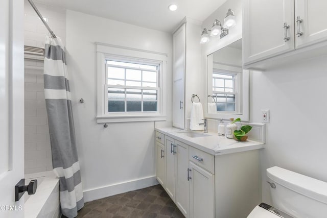 bathroom with toilet, recessed lighting, baseboards, and vanity