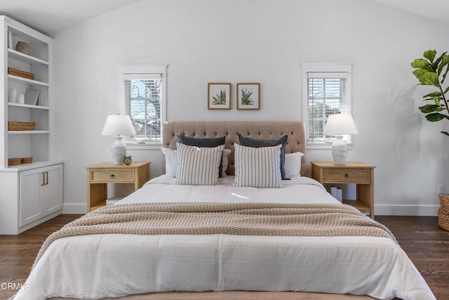 bedroom with multiple windows, vaulted ceiling, and dark wood finished floors